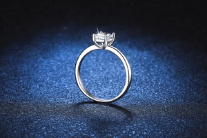 Side view of 1 carat emerald cut moissanite ring in 925 sterling silver four-prong setting