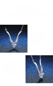 Detail of Moissanite V-shaped pendant necklace with water drop stone on navy background