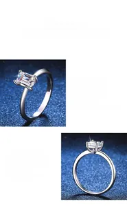 Close-up of S925 silver rings with emerald and radiant cut moissanite in 4-prong setting
