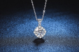 Close-up of S925 silver necklace featuring a 1ct Moissanite pendant on blue background
