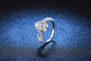 Macro view of pear cut moissanite halo ring with twisted pavé band in 925 silver