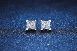 Detail of square princess cut moissanite stud earrings in a four-prong heart setting