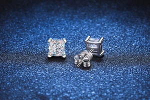Detail of square princess cut moissanite stud earring with silver four-prong setting