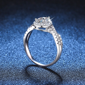 Luxurious S925 sterling silver halo ring with 1ct pear cut moissanite on blue background