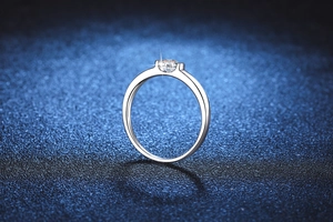 Macro shot of 0.5ct moissanite solitaire ring with brilliant round cut and silver band