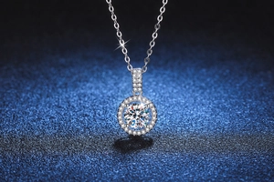 Macro shot of S925 sterling silver moissanite pendant with halo setting on blue surface