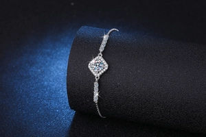 Close-up of S925 silver halo bracelet with sparkling square moissanite on a black stand