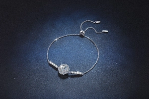 Macro shot of silver sunflower slider bracelet featuring a brilliant 1ct moissanite center