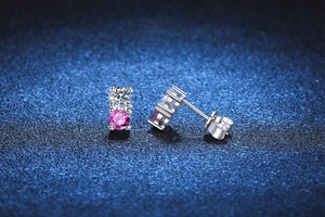 Macro view of S925 sterling silver stud earrings with round pink and white moissanite stones