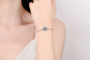 Close-up of s925 silver sunflower bracelet with 1 carat moissanite on female wrist