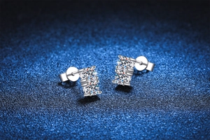 Macro shot of silver S925 earrings featuring double moissanite stones in four-prong settings