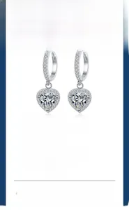 Detail of s925 silver heart-shaped moissanite earrings with a secure six-prong setting