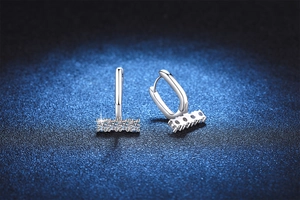 Macro detail of S925 silver hoop earrings with four brilliant round cut moissanite stones