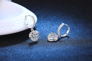 Macro detail of S925 sterling silver heart-shaped moissanite earrings with fine pave setting