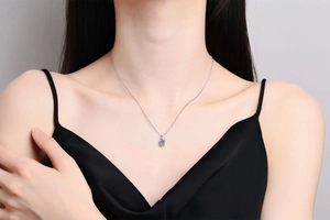 Close-up of S925 sterling silver necklace with a 1 carat round cut moissanite pendant