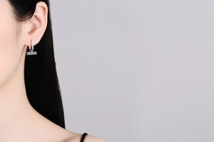 Close-up of S925 silver U-shaped earrings with moissanite on a model