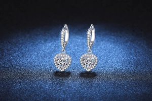 Detail of heart-shaped moissanite drop earrings with sparkling pavé micro-inlay accents