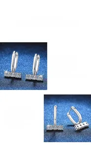 Detail of polished S925 silver U-shape earrings with moissanite channel setting
