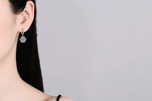 Detailed close-up of a luxury S925 silver rose-shaped earring with 1ct moissanite on model