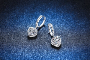 Macro shot of heart-shaped moissanite earrings in S925 sterling silver with halo pavé