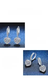 Detailed view of heart-shaped moissanite earrings with pavé set diamond connectors
