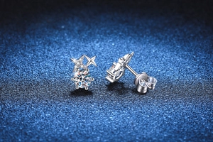 Détail de boucles d'oreilles étoile en argent S925 avec moissanite sur fond bleu