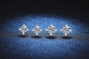 Macro detail of S925 silver stud earrings with moissanite stones in four-prong star setting