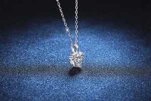 Macro shot of s925 silver heart necklace featuring 1 carat moissanite in 3-prong setting
