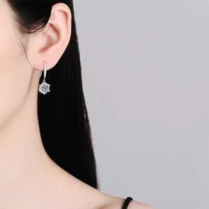 Elegant S925 sterling silver snowflake earrings featuring D color moissanite on model