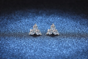 Macro detail of S925 silver stud earrings with three sparkling moissanite stones