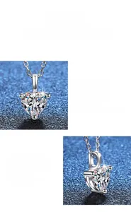 Macro detail of heart-cut moissanite pendant with polished silver setting on blue fabric