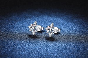Close-up of S925 silver stud earrings featuring brilliant Moissanite in four-claw star setting