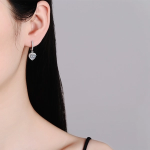 S925 sterling silver heart-shaped moissanite earrings shown on a model for elegant look