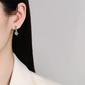 Elegant S925 sterling silver drop earrings with four-claw moissanite stones on model