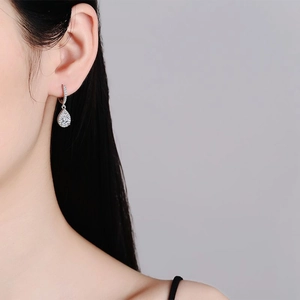 Classic pear-cut moissanite drop earrings in S925 sterling silver worn by a model