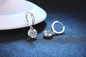 Macro detail of S925 sterling silver hoop earrings featuring sparkling moissanite stones