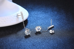Macro detail of S925 silver fringe earrings with six-claw moissanite and long chain