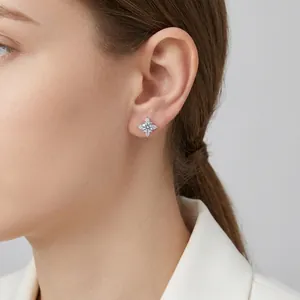 Elegant S925 sterling silver snowflake stud earrings with moissanite on ear model