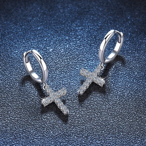 Polished S925 silver cross drop earrings with pavé moissanite on blue leather background