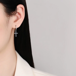 Sparkling S925 sterling silver cross earrings with moissanite pavé on female model