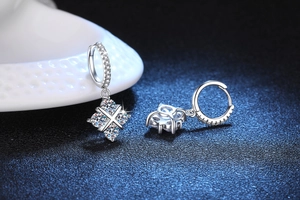 Macro shot of S925 sterling silver hoop earrings with sparkling moissanite dangles