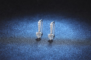Macro shot of S925 sterling silver S-curve earrings with moissanite drop pendants