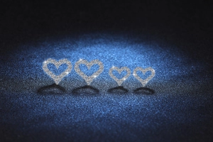 Detailed macro view of S925 silver heart stud earrings with sparkling pavé moissanite