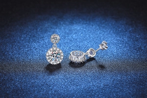 Macro detail of S925 silver halo moissanite earrings showing fine craft and stone sparkle