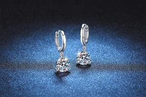Macro detail of S925 sterling silver hoop earrings with 4-prong moissanite stones