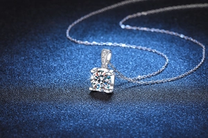 Macro detail of 1 carat moissanite pendant with classic four-prong setting and brilliant cut