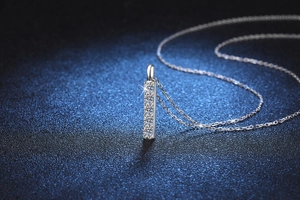 Macro close-up of a s925 silver necklace featuring a sparkling row of pavé set moissanite