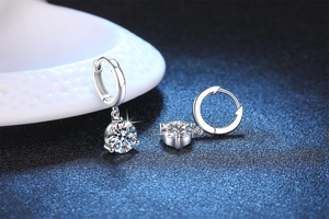 Macro shot of S925 sterling silver hoop earrings with four-prong set moissanite stones