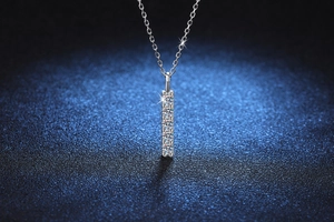 Detail of s925 sterling silver necklace featuring a sparkling vertical moissanite pavé pendant
