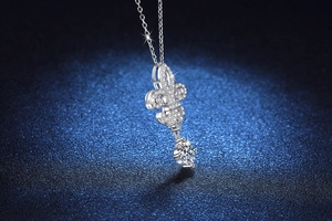 Macro view of S925 sterling silver fleur-de-lis pendant necklace with brilliant moissanite stone